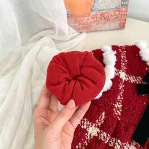 Close-up of red plush hair scrunchie with soft velvet texture for holiday accessories