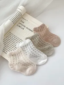 Detail view of four-color mesh summer baby socks with breathable hollow knit pattern