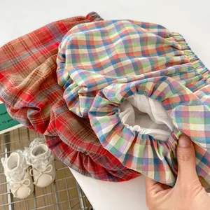 Three pairs of cotton plaid baby bloomers with elastic waistbands in various colors