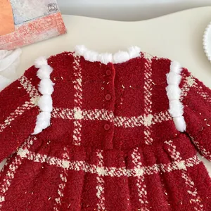 Detail of red tweed dress with white faux fur collar and festive gold shimmer threads