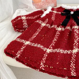 Detail of red tweed girl dress with velvet bow and white faux fur collar trim