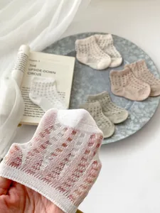 Detail showing breathable mesh texture and earthy tones of combed cotton summer baby socks