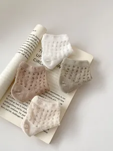 Detail of ultra-thin breathable mesh baby socks in neutral solid colors for summer
