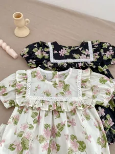 Detail of floral baby girl romper with square white lace collar and ruffle trim accents