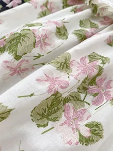 Close-up of baby romper fabric featuring fresh pink floral patterns on white cotton