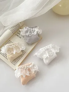 Detailed view of breathable mesh cotton socks with layered lace lace and floral embroidery