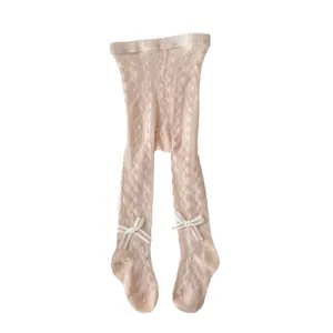 Pink hollow knit baby tights with cute white ribbon bows and breathable mesh texture