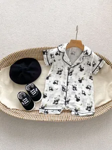 Short sleeve baby romper featuring cute panda and bamboo prints on white cotton fabric