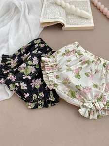 Detailed view of floral cotton bloomers with elastic waist and layered ruffle hems