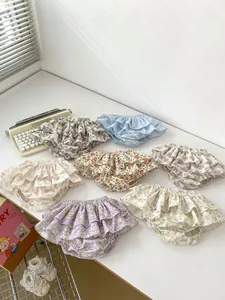 Detail of floral infant bloomers showing soft cotton ruffles and tiered frill designs