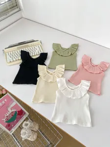 Detail of ribbed knit baby vests with ruffled necklines in five assorted colors