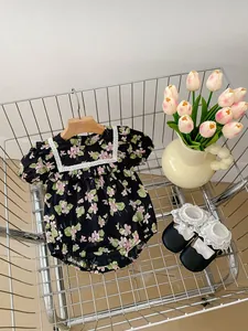 Floral baby bodysuit with lace collar and matching shoes in a vintage shopping basket