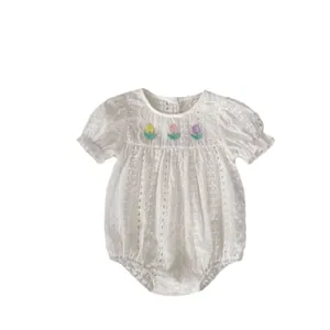 White cotton baby bodysuit with lace eyelets and colorful tulip floral embroidery