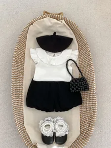 Flat lay of baby girl summer outfit featuring bloomer shorts and ribbed sleeveless top
