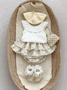 Flat lay of baby girl sleeveless ribbed vest and purple floral tiered ruffle skirt set