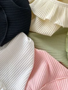 Macro detail of soft ribbed knit cotton fabric in multiple pastel colors for baby t-shirts