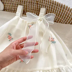 Cream baby romper dress with floral embroidery and large organza bow detail