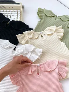 Flat lay of ribbed baby t-shirts with ruffle collars and flutter sleeves in five colors