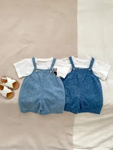 Detail showing baby denim overalls with cute bear print and white rabbit t-shirt set