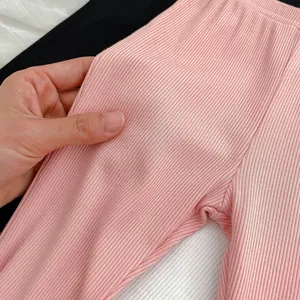 Pink rib-knit flared leggings for girls featuring elastic waist and breathable fabric