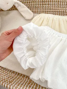 Detail of soft bubble cotton fabric and elastic waistband on baby summer bloomers