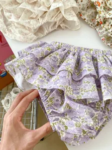 Detailed macro view of triple-layered floral ruffle hem and soft elastic cotton fabric
