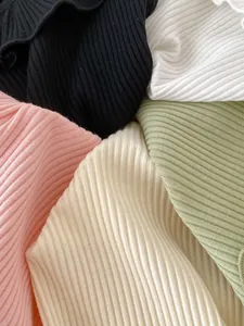 Close-up of ribbed knit fabric texture in multiple colors for sleeveless baby girl tops