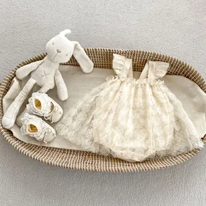 Close-up of baby girl romper dress with floral mesh skirt, matching shoes, and plush rabbit