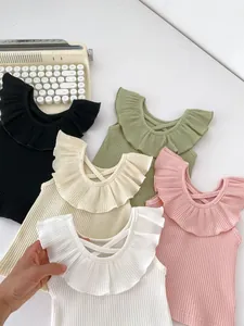 Detail of ribbed girls' sleeveless tops with ruffle collar in multi-color options