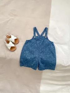 Detail of infant denim overalls featuring cute bear prints and white polka dots