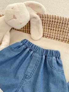 Detail of toddler blue denim shorts with elastic waistband and side pockets