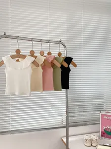 Close-up of five colorful ribbed toddler tank tops with ruffled flying-edge collar