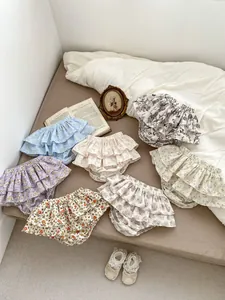 Flat lay of floral cotton baby bloomers with ruffled layers and elastic waist