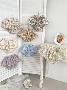 Close-up of floral baby bloomers with ruffled layers and delicate cotton fabric textures