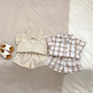 Detail of toddler summer cotton sets featuring beige stripes and brown plaid patterns