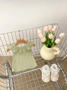 Close-up of light green ruffled sleeveless top with ribbed fabric in a cute shopping cart