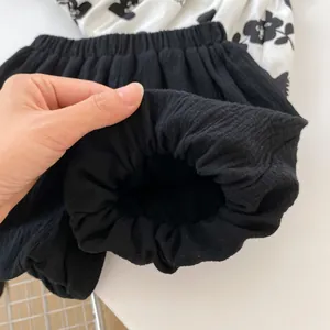 Detail view of black bloomers shorts with elastic waistband and soft cotton fabric texture