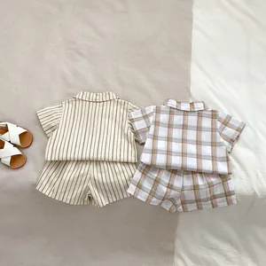 Detailed flat lay of striped and checkered cotton-linen summer sets for baby boys
