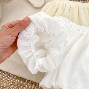Girls summer cotton linen bubble shorts featuring elastic cuffs and textured white fabric