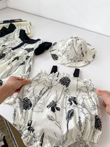 Detail of floral baby romper set with snap buttons and elastic waist for summer