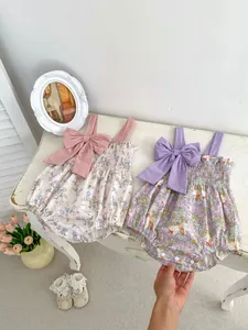 Detail of floral baby bodysuits with large bow straps and cute rabbit prints