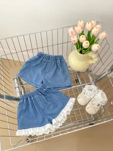 Detail view of two denim shorts with lace trim and elastic waist in a shopping cart