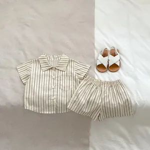 Flat lay of striped cotton linen shirt and shorts set for baby boys summer outfit