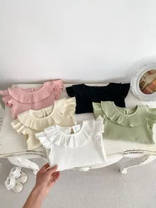 Detail view of cotton ribbed baby t-shirt featuring ruffle collar and flutter sleeves
