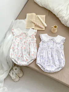 Detail of floral baby bodysuits with ruffle collar, tulip prints and lace infant shoes
