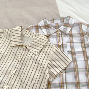 Detail of boys summer shirts showing striped and plaid patterns with chest pockets