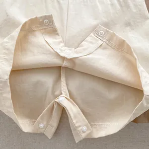 Neutral cream baby romper with cotton texture and snap buttons for easy diaper changes