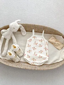Detailed set of baby bunny bodysuit with matching bow headband and lace shoes in basket