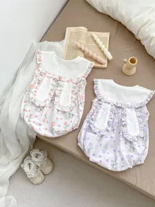Detail of floral baby rompers with cute rabbit ears and ruffled collar for summer