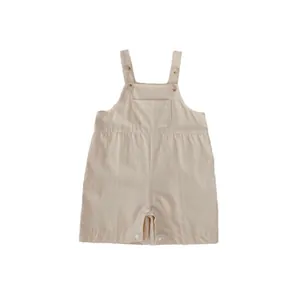 Neutral beige cotton baby romper with adjustable straps and front pocket for summer wear